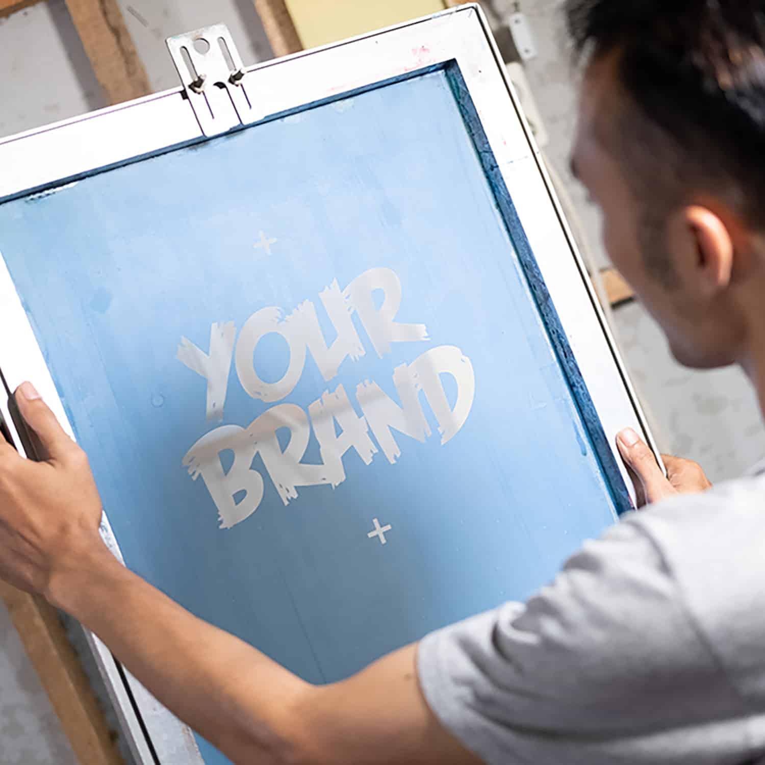 Asian men carefully observe the film result on the silkscreen